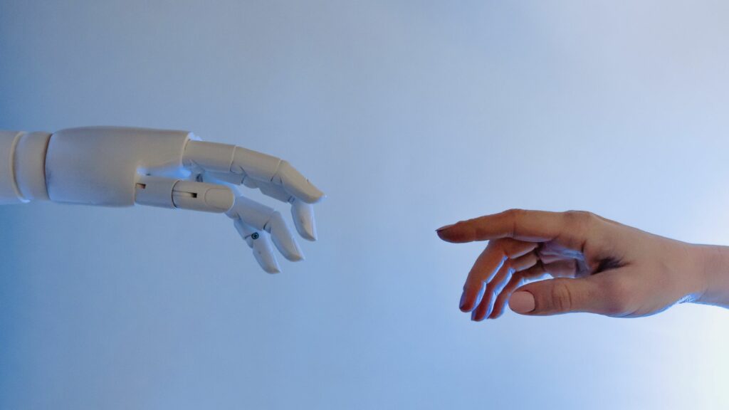 Hand reaching out to robot hand